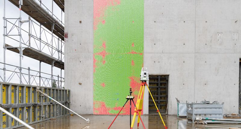 Leica iCON case study – Leica iCON total station in front of large concrete wall.