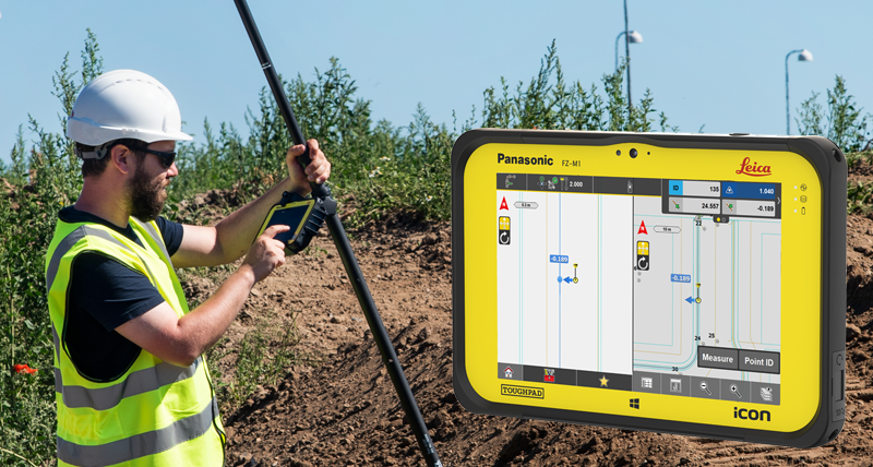 Bouwvakker in geel veiligheidsvest zet punten uit met een Leica iCON CC80 veldcontroller.