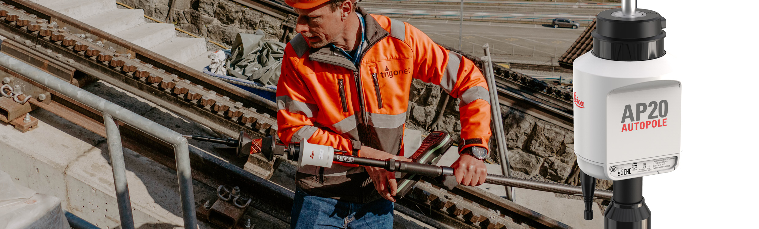 Surveying engineer surveying the corner of a railing with an upside-down Leica AP20 AutoPole.