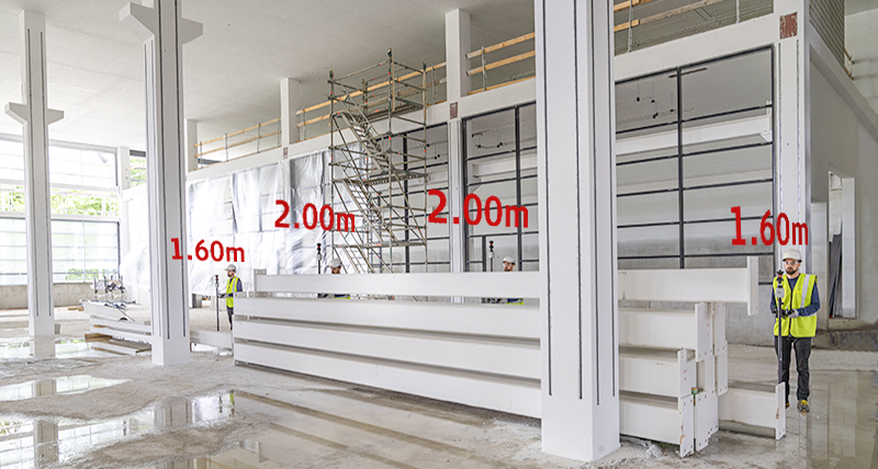 Surveyor on a construction site uses AP20 prism pole to measure over obstacles with height changes recorded automatically.